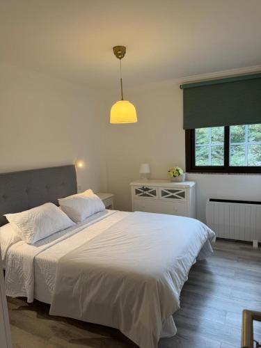 a bedroom with a large white bed and a window at Lavilla1XO in Valverde