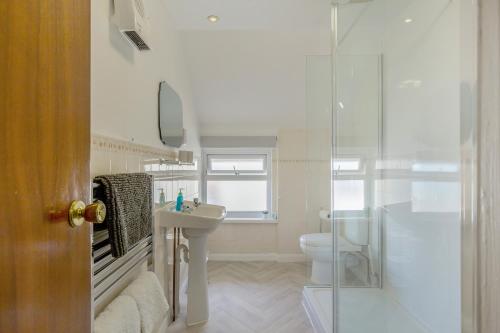 a bathroom with a sink and a toilet and a shower at The Lookout in Ilfracombe