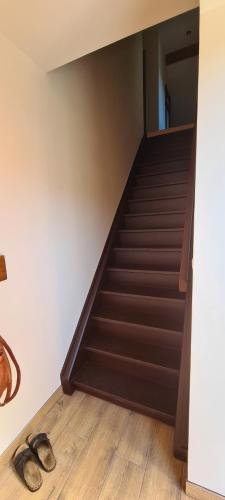 a staircase in a room with two pairs of shoes at Sosnówka in Kolonowskie