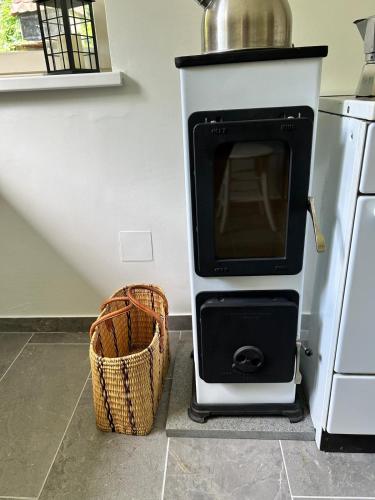 a stove in a kitchen with a basket next to it at Nanus Sommerfrische in Hardegg