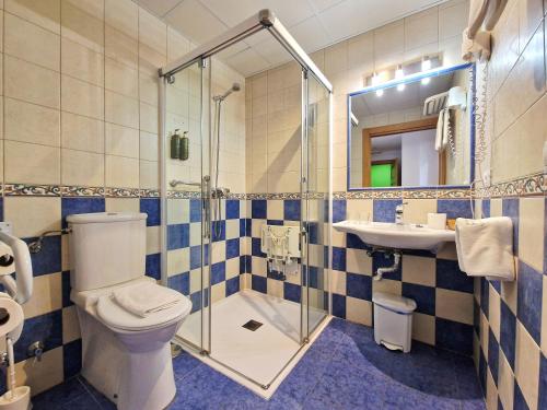 a bathroom with a toilet and a sink and a shower at Hotel Verdemar by Grupo A Cobijo in Lamadrid