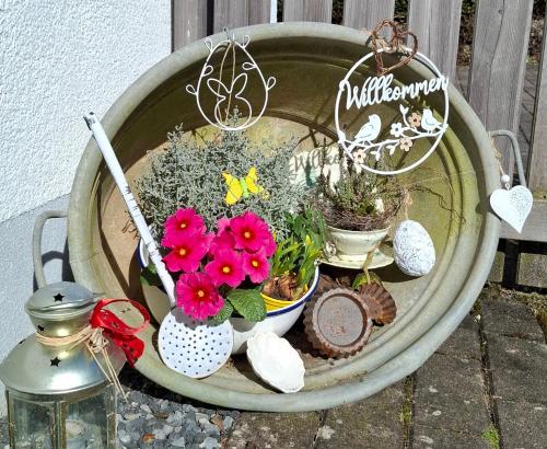 a planter with flowers and other plants in it at Auszeit im Jugendstil in Schopfloch