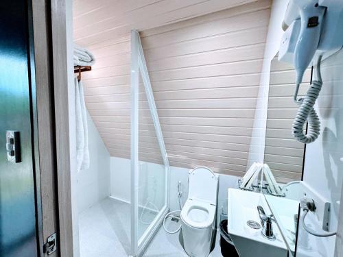 a small bathroom with a toilet and a sink at Inato Suites- Teepee House in Panglao Island