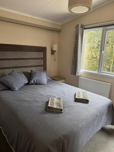 a bedroom with a large bed with two towels on it at Jasmine Corner - entertainment passes included - message for longer stays in Ringwood