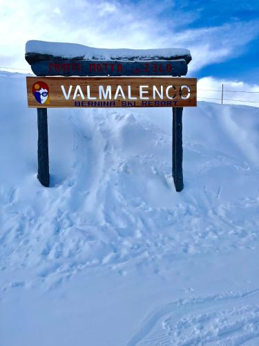 a sign on top of a snow covered mountain at Baita Snow Valtellina in Chiesa in Valmalenco