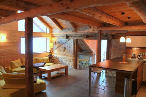 a living room with a couch and a table at 10214 Chalet d'exception nature sport et bien être sauna,jacuzzi hammam frigidarium in Cervières