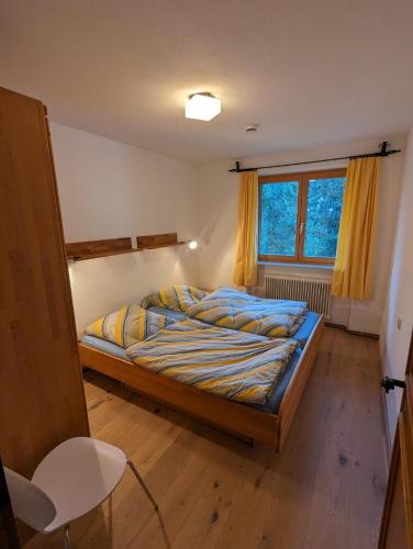 a bedroom with a bed and a window at Ferienhaus Lengau in Saalbach-Hinterglemm