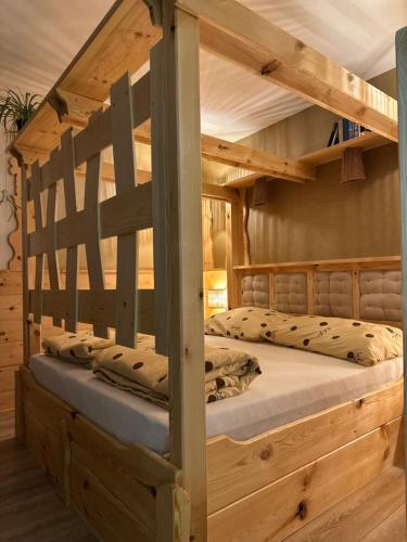 a bedroom with a wooden bunk bed in a cabin at Edenski vrt in Ivančna Gorica