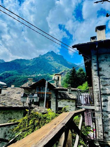 a view of a village with a mountain in the background at Baita Snow Valtellina in Chiesa in Valmalenco