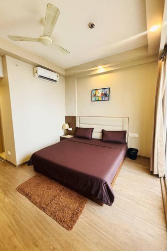a bedroom with a large bed in a room at The Pineapple Suite with Gorgeous Views in Greater Noida