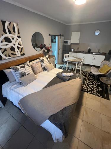 a large bed in a room with a kitchen at Little West in Margate
