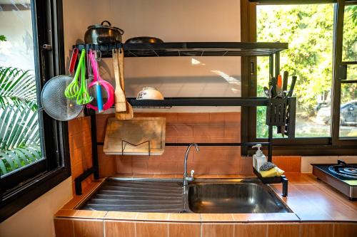 a kitchen with a sink and a window at Zen Rise in Ko Phangan