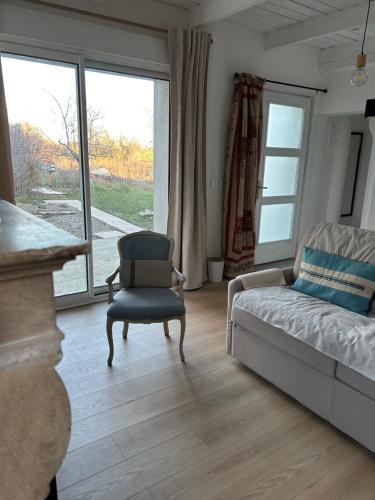 En eller flere senge i et værelse på Le Cottage