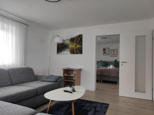 a living room with a couch and a table at Ferienwohnungen Bella in Reutte