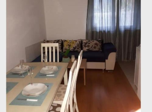 a living room with a table and a couch at Apartment Dijana in Bakar