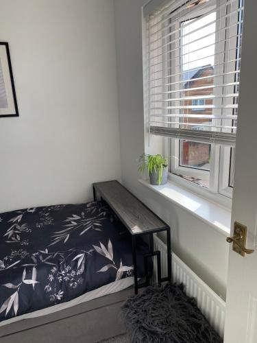 a small bedroom with a bed and a window at Garden view Cosy Single Room in Derby