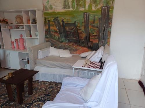 a living room with a couch and a table at Casa do Mato I in São Lourenço do Sul