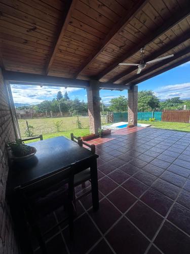 a patio with a table and a view of a field at RyC La Casita Mirador Del Lago in Villa Parque Siquiman