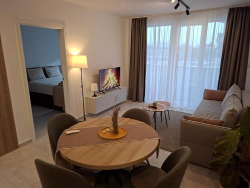 a living room with a table and a couch at Silver 2 & SPA in Veliko Gradište