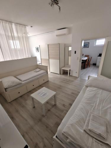 a living room with a couch and a table at Antonio Appartement in Steinabrückl