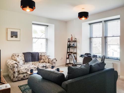 a living room with a couch and a chair at Liquorstane - Uk40568 in Falkland
