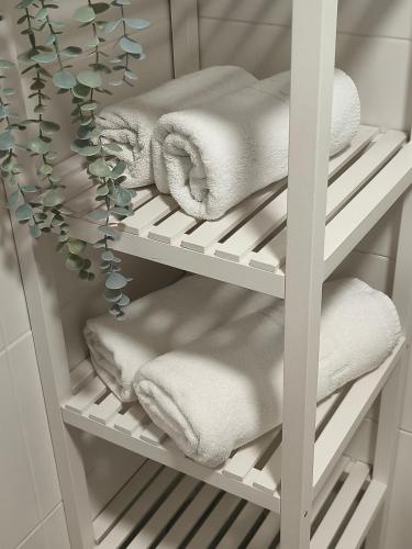 a white towel rack with towels on it at Benalbeach Smart Suite in Benalmádena