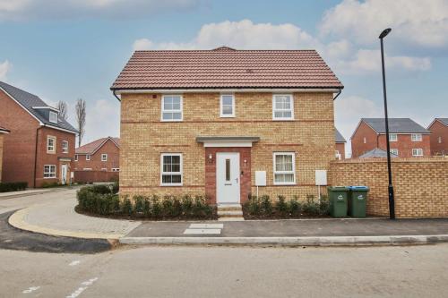 a brick house with a white door on a street at Spacious, 3BR, Coventry House | Sleeps 9 | Parking in Canley