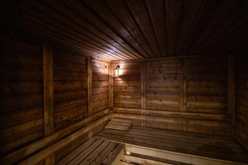 an empty wooden sauna with wooden floors and ceilings at Grand Hôtel des Bains SPA in Fouras