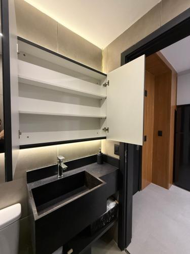 a bathroom with a sink and a toilet at Sky Designer Alphaville - 1611 in Barueri