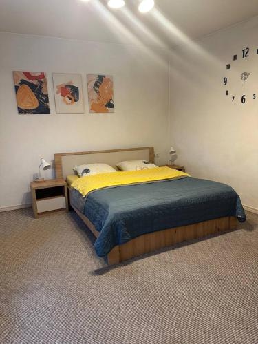 a bedroom with a bed and a clock on the wall at Гостьовий двір in Yaremche