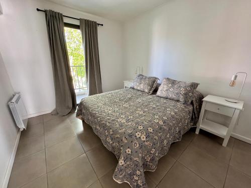 a bedroom with a bed and a window at NUX Tandil in Tandil
