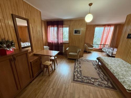 a bedroom with a bed and a desk and a table at Hotel palas tatariv in Tatariv