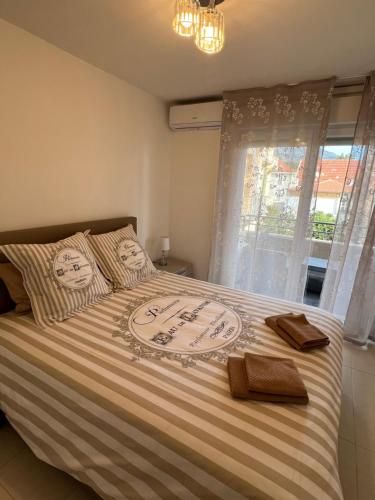 a bedroom with a bed with two towels on it at One minute to the Beach in Menton