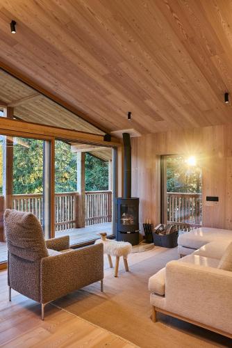 a living room with a couch and a fireplace at Eagle & Marmot, Carezza Dolomites in Carezza al Lago