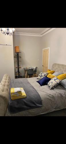 a bedroom with a bed with pillows and a table at Cambridge Villa St Annes in Lytham St Annes