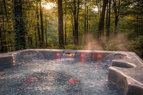 a hot tub in the middle of a forest at Architectural Woodland Spa Estate - 2 Hot Tubs in Clapton in Gordano
