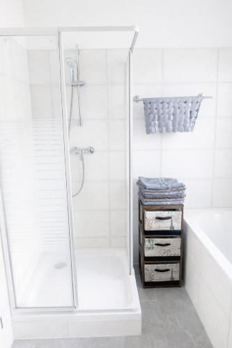 a white bathroom with a shower and a tub at Bali Spirit - Toplage Usingen in Usingen