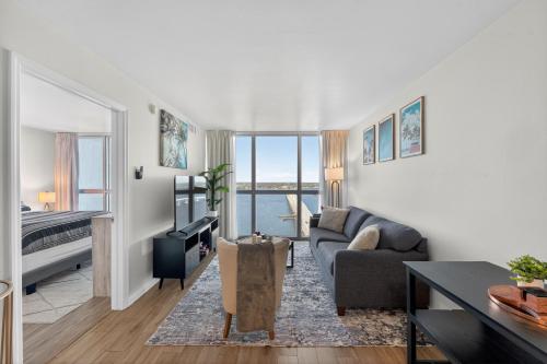 a living room with a couch and a table at Luxe Stay Water & City View in Downtown Ft Myers in Fort Myers
