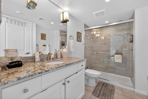 a bathroom with a shower and a sink and a toilet at Luxe Stay Water & City View in Downtown Ft Myers in Fort Myers