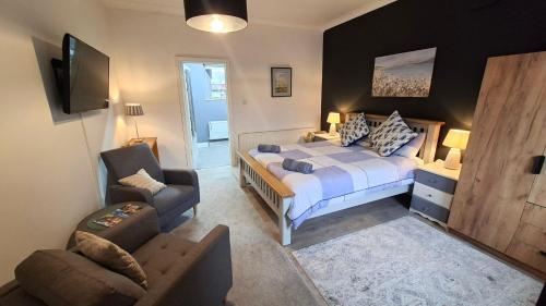 a bedroom with a bed and a chair and a couch at The Serendipity Suite - A Scenic Countryside Hideaway in Letterkenny