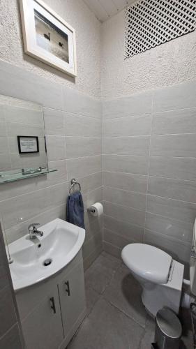 a bathroom with a white sink and a toilet at The Serendipity Suite - A Scenic Countryside Hideaway in Letterkenny