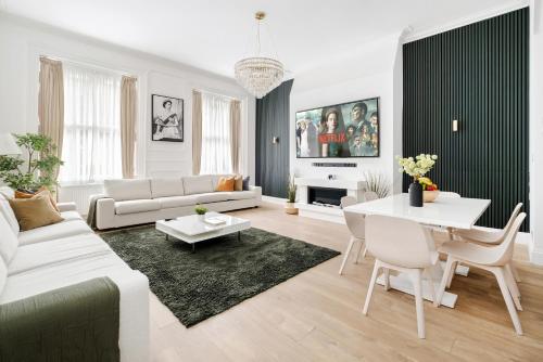 a living room with a white couch and a table at LONDONERS - Marylebone Serviced Apartments in London