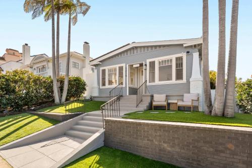 a white house with palm trees in front of it at Cliff View - Prime Downtown La Jolla in San Diego