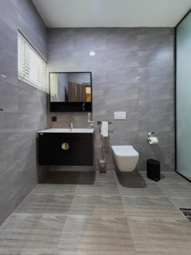 a bathroom with a sink and a toilet at Executive Cozy Suite at THE HIDDEN DOMUS I Saltpond Suite in Madina