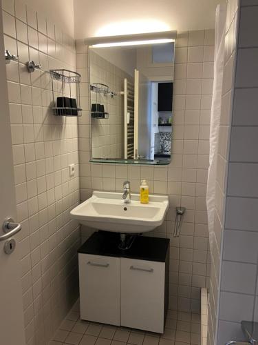 a bathroom with a sink and a mirror at FeWo Seliger am Schloßplatz in Meersburg