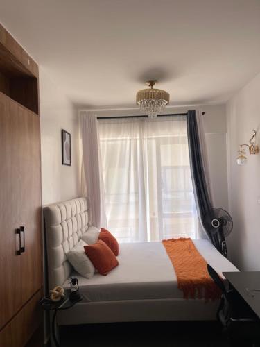 a bedroom with a large bed with a window at Sk home in Kiambu