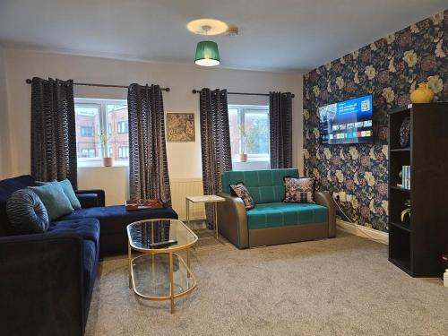 a living room with two couches and a tv at StayZen Apartments - Luxury Central Apartment with Parking - sleeps 8 in Woking