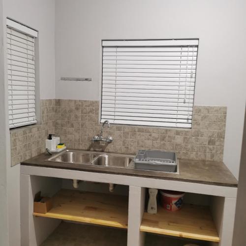 a kitchen counter with a sink and a window at Sune's self catering 2 in Worcester
