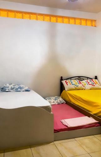 two beds sitting next to each other in a room at Beach Village Rest in Tarrafal