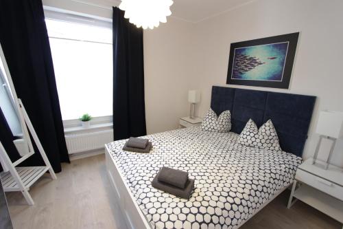 En eller flere senge i et værelse på Apartamenty Perły Bałtyku